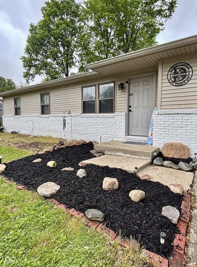 property entrance with brick siding