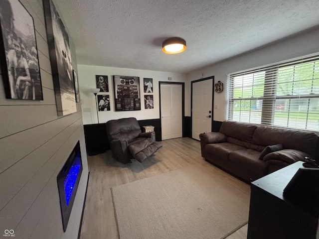 living room with a textured ceiling and wood finished floors