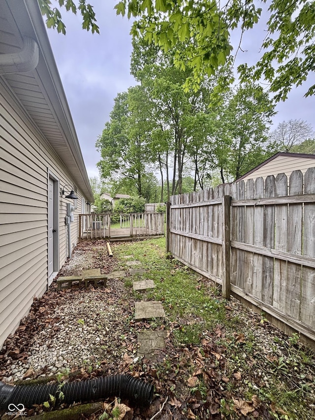 view of yard with a wooden deck and fence