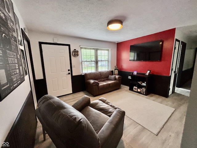 living room with a textured ceiling and wood finished floors