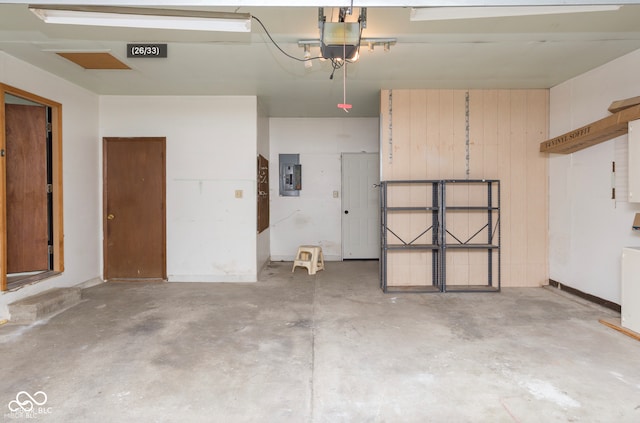 garage with electric panel and a garage door opener