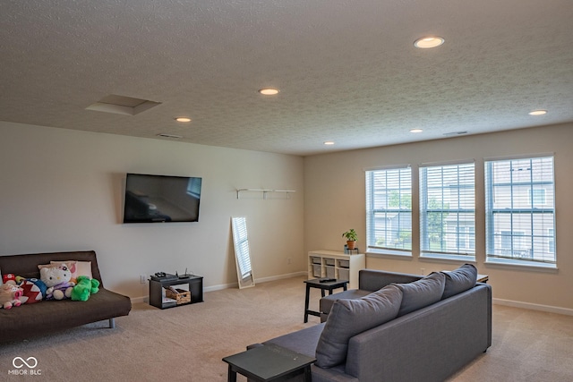 living area featuring light colored carpet, recessed lighting, baseboards, and a textured ceiling