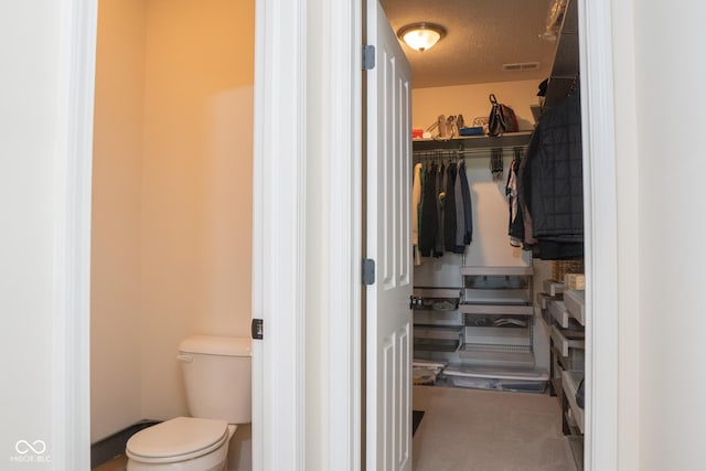 walk in closet featuring carpet