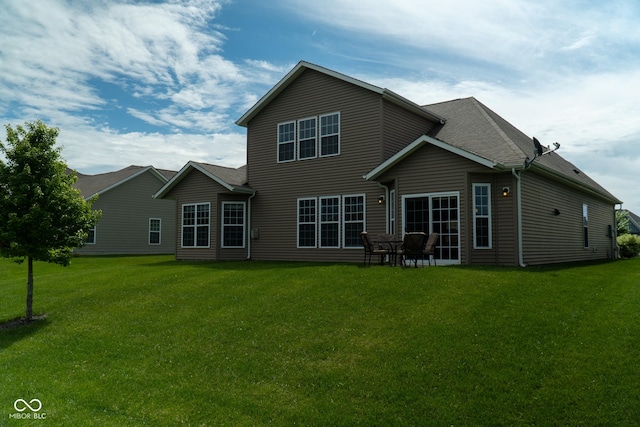 back of house with a lawn
