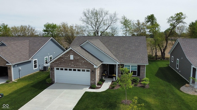 509 Tulip Tree Dr, Lapel, IN 46051 - view of front of home with brick siding, a garage, central AC unit, concrete driveway, and a front yard