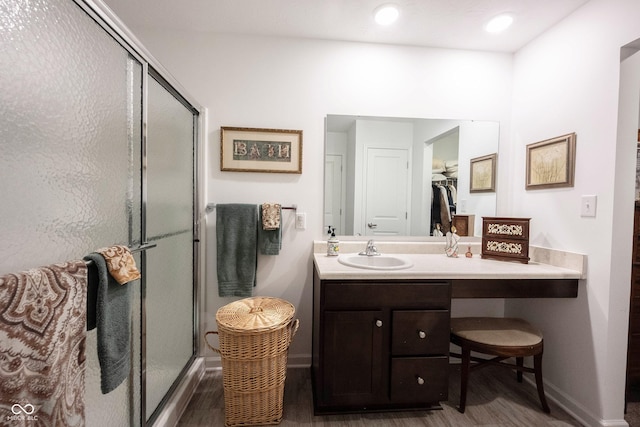509 Tulip Tree Dr, Lapel, IN 46051 - bathroom with baseboards, wood finished floors, a shower stall, vanity, and recessed lighting
