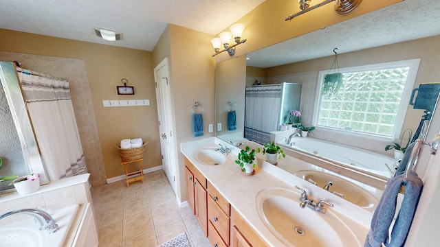 18247 Kinder Oak Dr, Noblesville, IN 46062 - full bathroom featuring a textured ceiling, a whirlpool tub, double vanity, tile patterned flooring, and baseboards