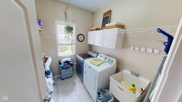 18247 Kinder Oak Dr, Noblesville, IN 46062 - clothes washing area with washer and dryer, cabinet space, and light tile patterned floors