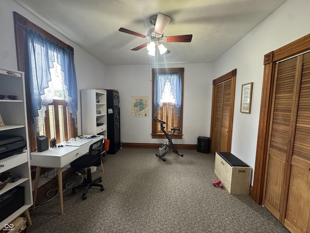 office space with ceiling fan, healthy amount of natural light, carpet flooring, and baseboards