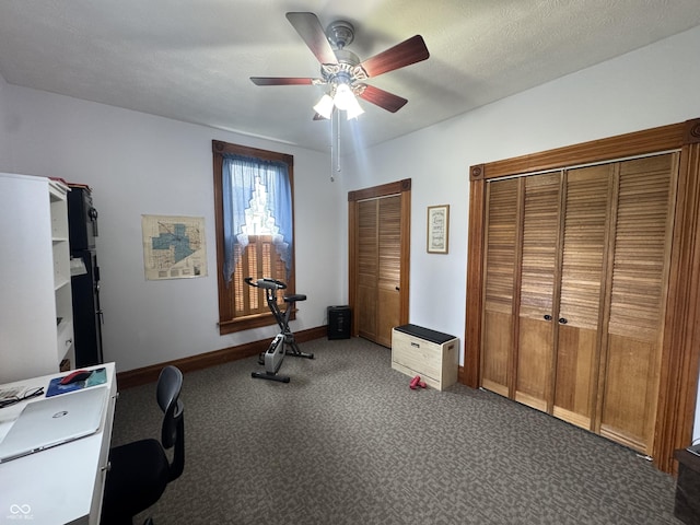 exercise area featuring ceiling fan, baseboards, and carpet