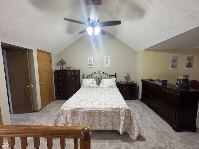 bedroom with light carpet, lofted ceiling, a textured ceiling, and a ceiling fan
