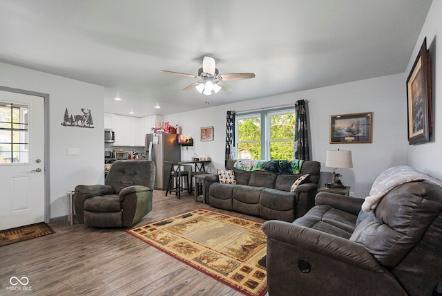 living room featuring wood finished floors, a ceiling fan, a healthy amount of sunlight, and recessed lighting