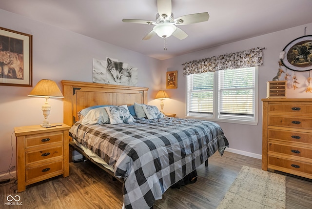 bedroom featuring baseboards, a ceiling fan, and dark wood-type flooring