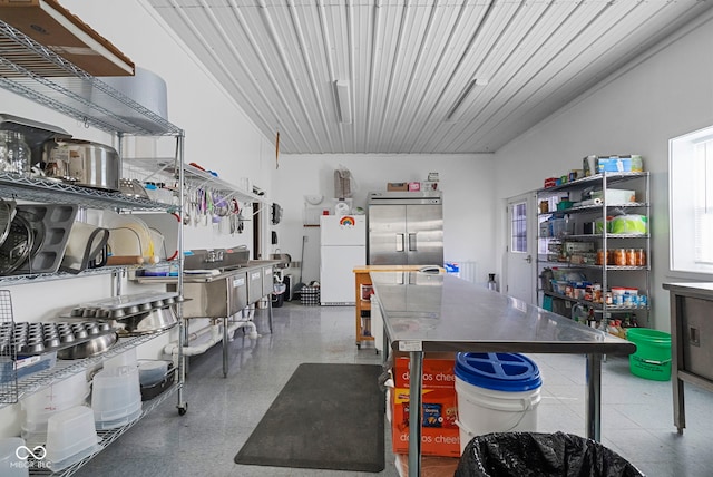 kitchen featuring freestanding refrigerator, a center island, and built in fridge