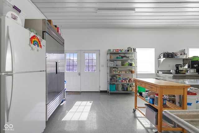 kitchen with freestanding refrigerator and open shelves