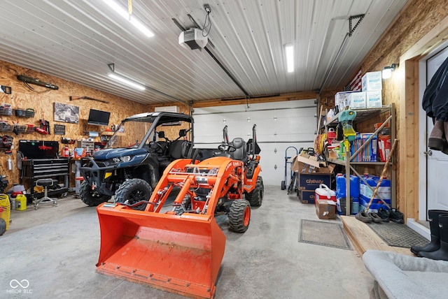 garage with a workshop area and a garage door opener