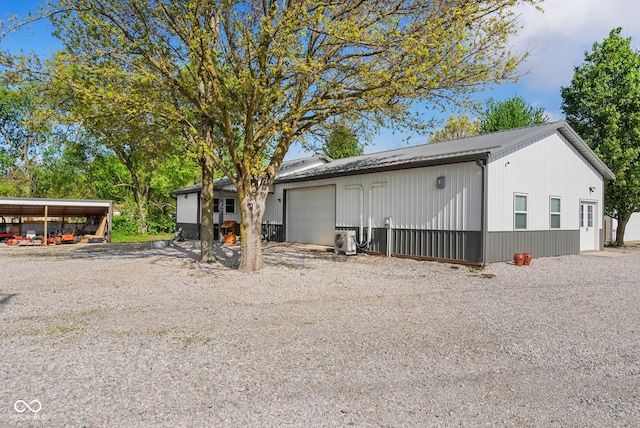 exterior space with metal roof and a garage