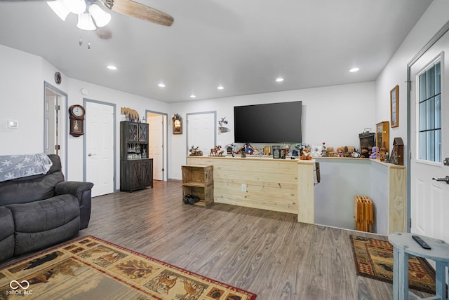 living area featuring wood finished floors, a ceiling fan, and recessed lighting