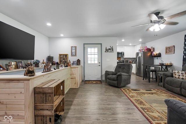 living room with recessed lighting, a ceiling fan, and dark wood finished floors