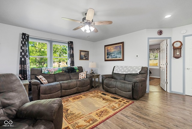 living room with a ceiling fan, baseboards, recessed lighting, and wood finished floors