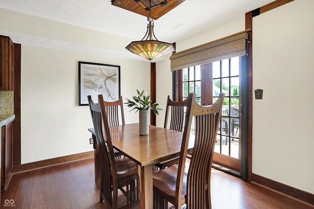 6505 Miramar Ct, Indianapolis, IN 46250 - dining room featuring baseboards and dark wood-type flooring