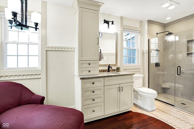 6505 Miramar Ct, Indianapolis, IN 46250 - full bathroom featuring wood finished floors, a stall shower, and healthy amount of natural light