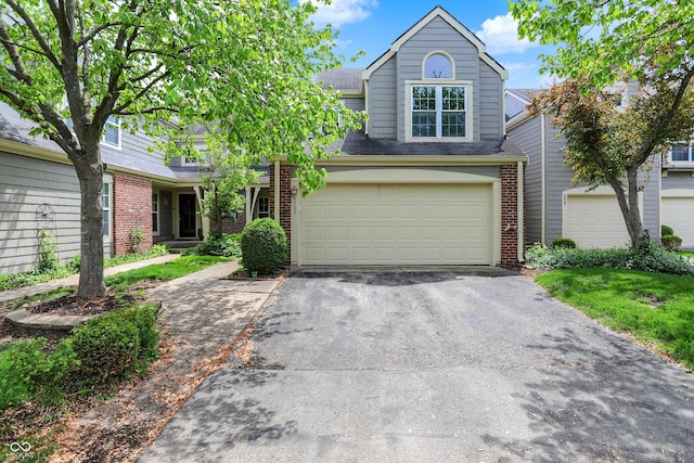 6505 Miramar Ct, Indianapolis, IN 46250 - view of front of property with asphalt driveway, brick siding, and a garage