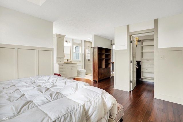 6505 Miramar Ct, Indianapolis, IN 46250 - bedroom with a decorative wall, a walk in closet, a closet, dark wood-type flooring, and a wainscoted wall