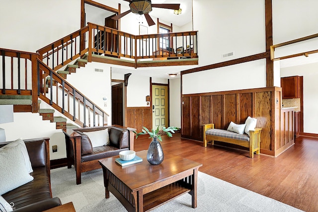 6505 Miramar Ct, Indianapolis, IN 46250 - living room featuring high vaulted ceiling, ceiling fan, stairs, wood finished floors, and baseboards