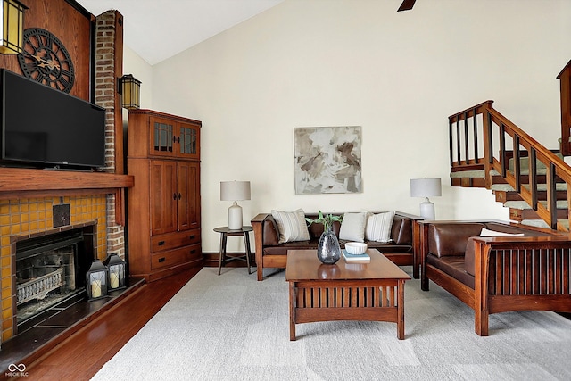 6505 Miramar Ct, Indianapolis, IN 46250 - living area with high vaulted ceiling, wood finished floors, a fireplace, stairway, and baseboards