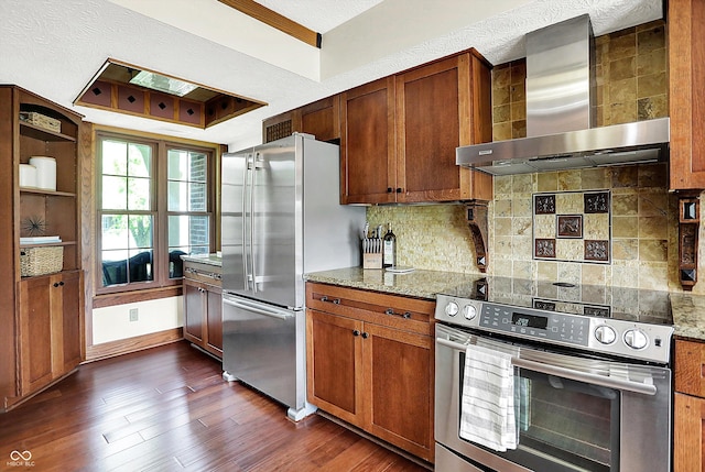 6505 Miramar Ct, Indianapolis, IN 46250 - kitchen with wall chimney exhaust hood, appliances with stainless steel finishes, dark wood-type flooring, backsplash, and light stone counters