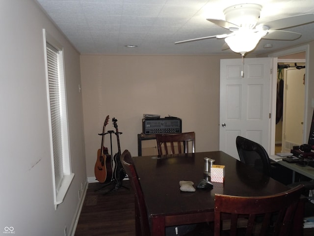 dining area featuring baseboards, dark wood-style floors, and a ceiling fan