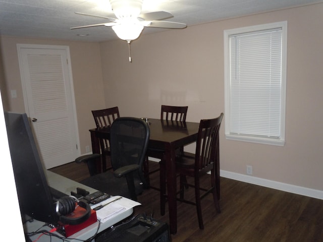 dining area featuring dark wood finished floors, baseboards, and a ceiling fan