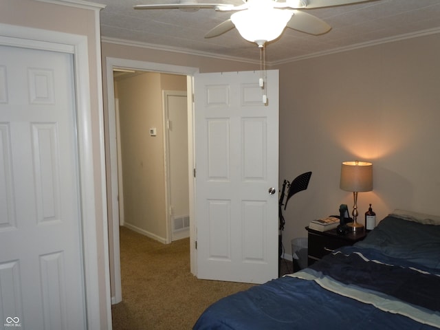 bedroom with ornamental molding, carpet, visible vents, a ceiling fan, and baseboards