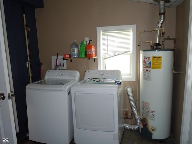 laundry room with laundry area, water heater, and washer and dryer