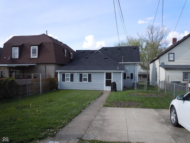 exterior space with a yard, a shingled roof, and fence