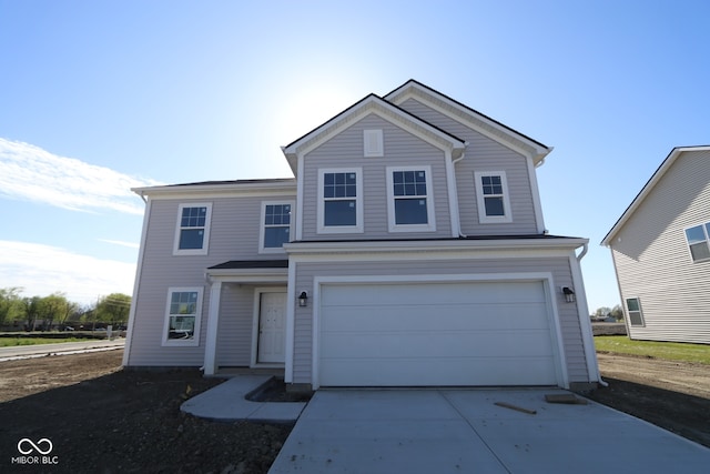 traditional-style home with concrete driveway and a garage
