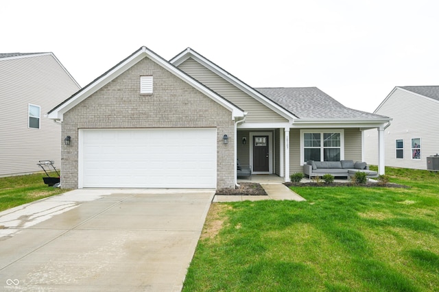 10107 Camp Creek Way, Indianapolis, IN 46229 - view of front of home featuring an attached garage, cooling unit, concrete driveway, a front lawn, and an outdoor hangout area