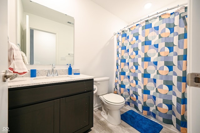 10107 Camp Creek Way, Indianapolis, IN 46229 - full bathroom featuring toilet, wood finished floors, vanity, visible vents, and a shower with shower curtain
