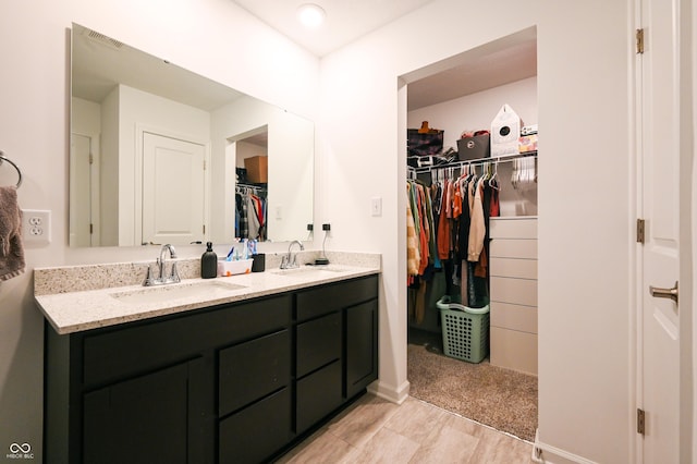10107 Camp Creek Way, Indianapolis, IN 46229 - full bath with a spacious closet, visible vents, double vanity, and a sink