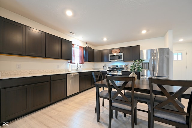 10107 Camp Creek Way, Indianapolis, IN 46229 - kitchen featuring stainless steel appliances, a wealth of natural light, visible vents, and light wood-style floors