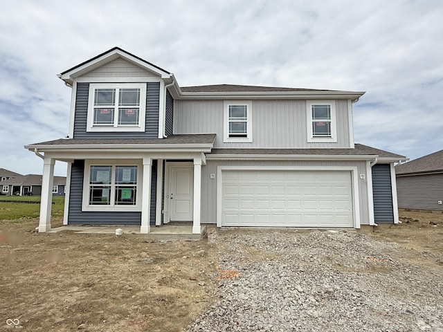 1428 Aster Dr, Shelbyville, IN 46176 - view of front facade with an attached garage, covered porch, and driveway