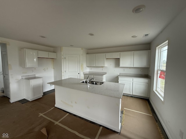 1428 Aster Dr, Shelbyville, IN 46176 - kitchen featuring a center island with sink and white cabinetry
