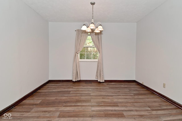 7228 Kimberly Ln, Plainfield, IN 46168 - unfurnished room with a chandelier, light wood-style flooring, and baseboards