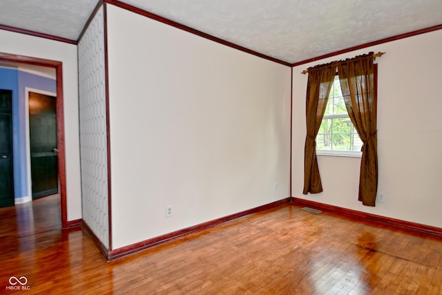 7228 Kimberly Ln, Plainfield, IN 46168 - empty room featuring crown molding, wood finished floors, baseboards, and a textured ceiling
