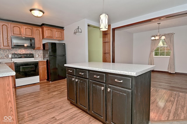 7228 Kimberly Ln, Plainfield, IN 46168 - kitchen with black appliances, light wood-type flooring, light countertops, and backsplash