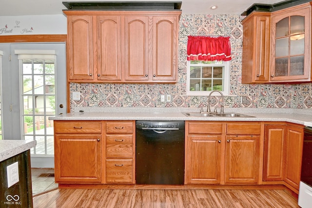 7228 Kimberly Ln, Plainfield, IN 46168 - kitchen with black dishwasher, a sink, light wood-type flooring, and light countertops