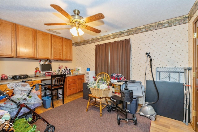 8111 Timberwood Dr, Plainfield, IN 46168 - office area with light wood finished floors, wallpapered walls, and ceiling fan