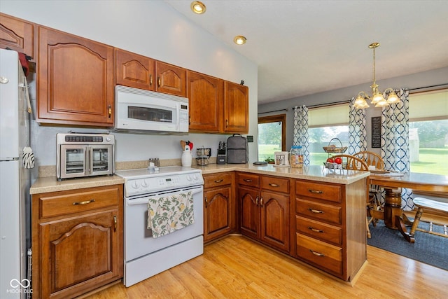 8111 Timberwood Dr, Plainfield, IN 46168 - kitchen with white appliances, a peninsula, light countertops, and recessed lighting