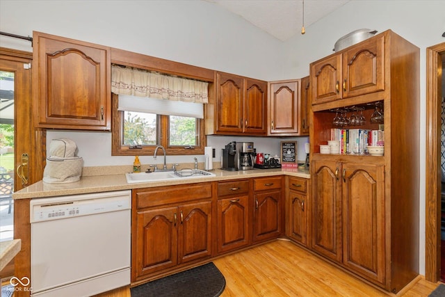 8111 Timberwood Dr, Plainfield, IN 46168 - kitchen featuring white dishwasher, a sink, light countertops, healthy amount of natural light, and lofted ceiling